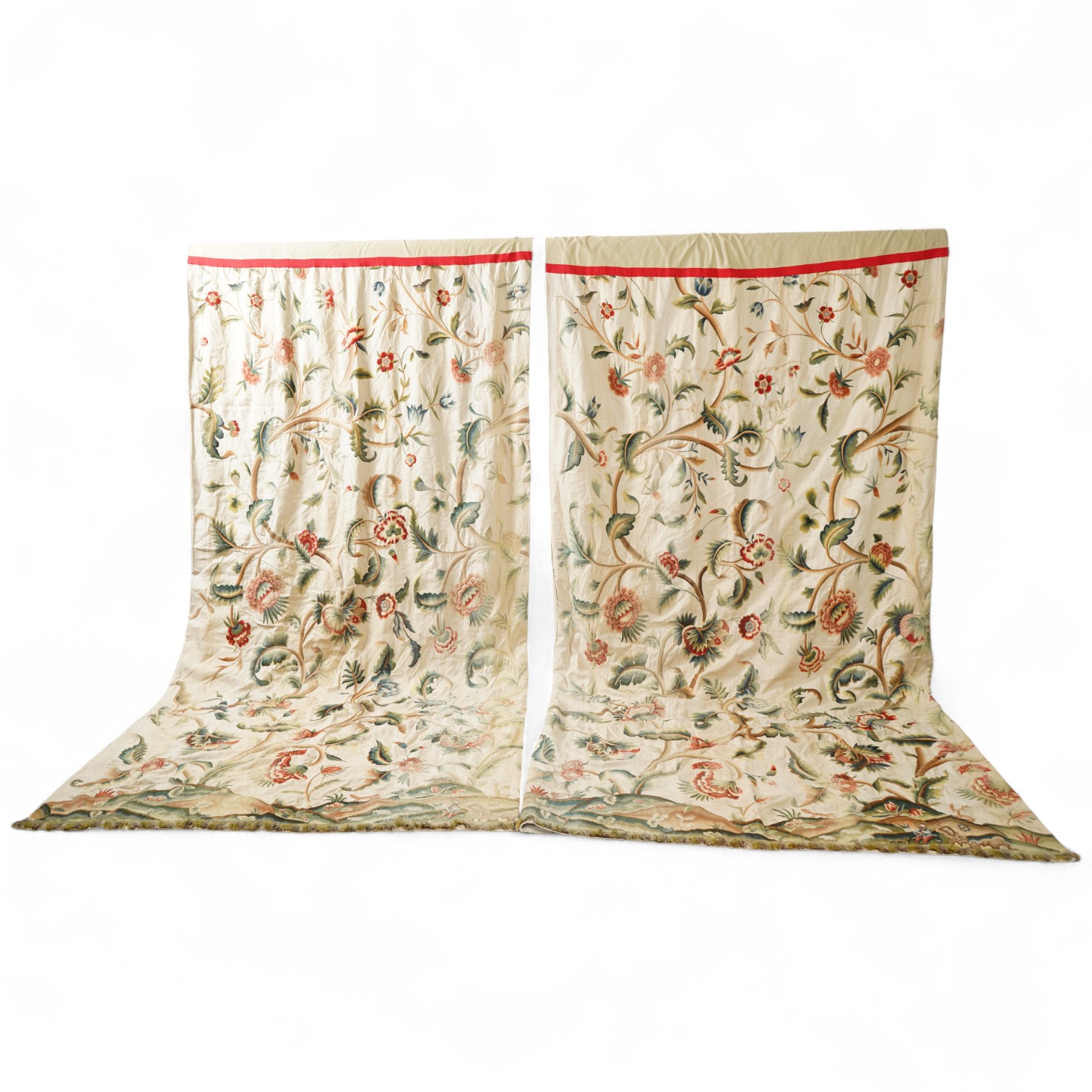 Six 20th century crewel work ‘Tree of Life’ cream linen curtains. Worked at the base in coloured wools depicting a pastoral scene of a shepherd playing a flute amongst sheep, deer, squirrels and flowers with a dog chasin